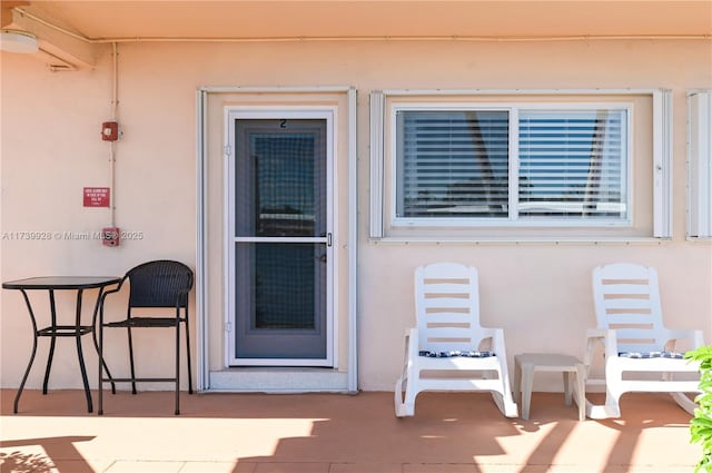 doorway to property with a patio