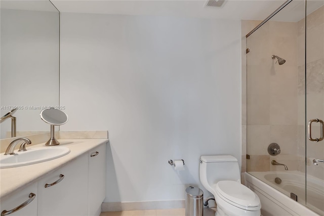 full bathroom with vanity, shower / bath combination with glass door, and toilet