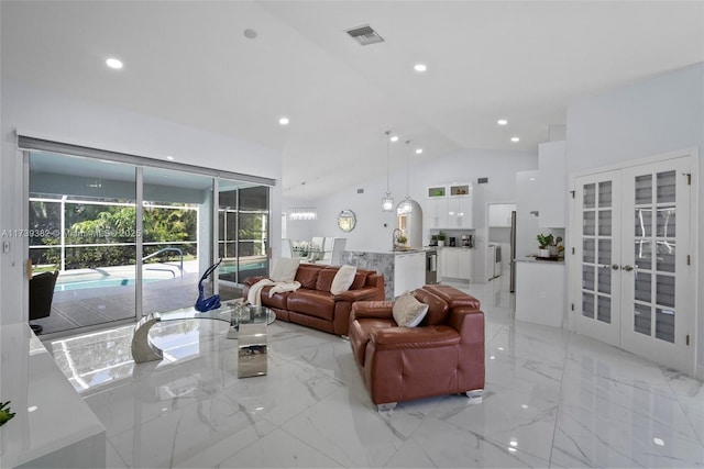 living room with sink, high vaulted ceiling, and french doors