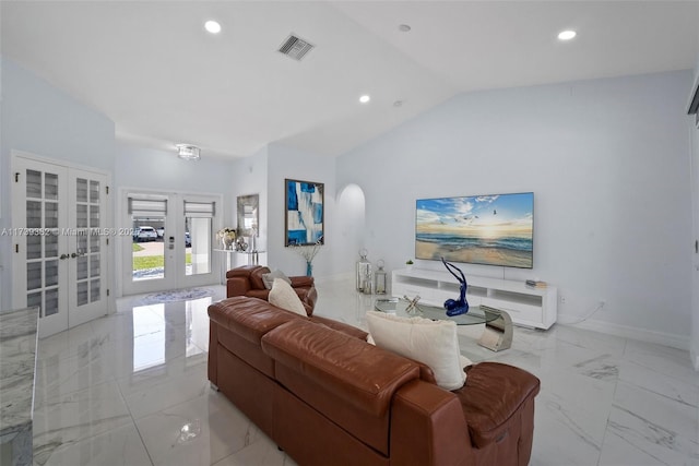 living room with vaulted ceiling and french doors