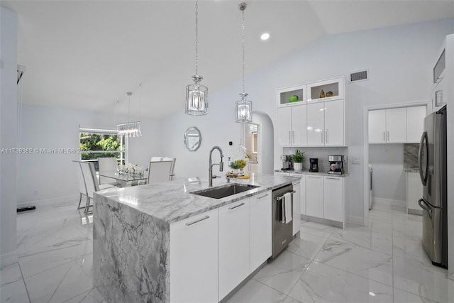 kitchen featuring sink, a kitchen island with sink, stainless steel appliances, light stone countertops, and white cabinets