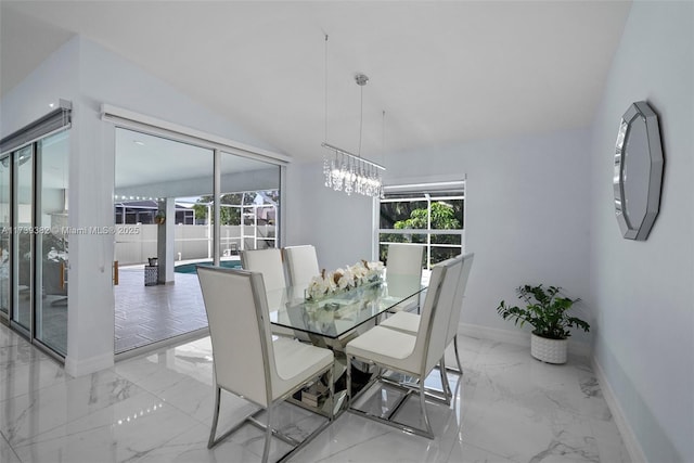 dining room featuring a healthy amount of sunlight and an inviting chandelier