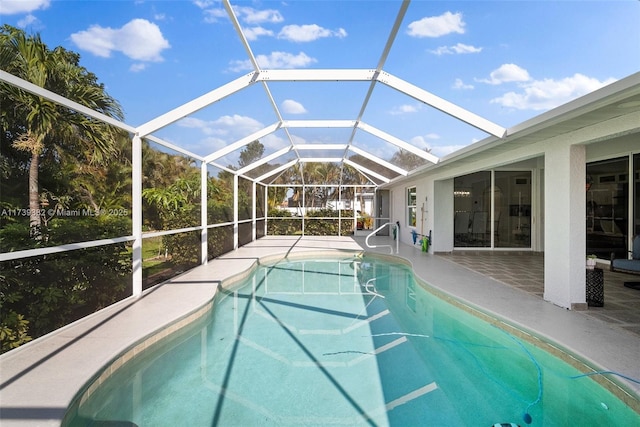 view of swimming pool with a lanai and a patio area