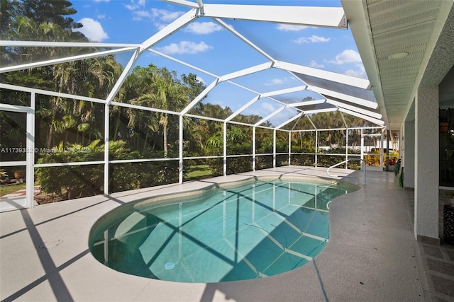 view of swimming pool featuring a patio and a lanai