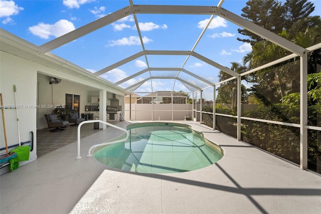 view of swimming pool with area for grilling, glass enclosure, and a patio