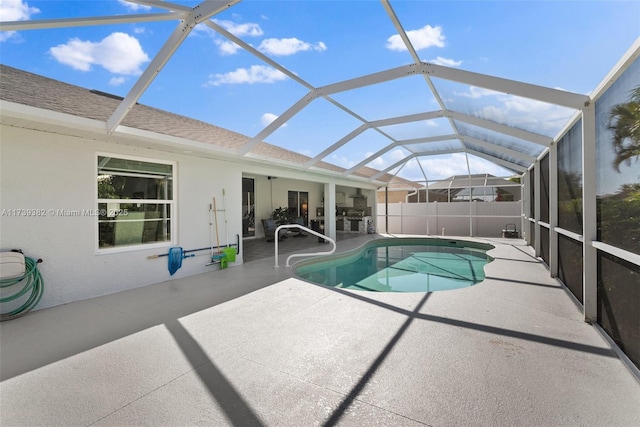 view of swimming pool featuring a lanai and a patio