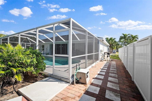 view of side of property with a patio and a lanai