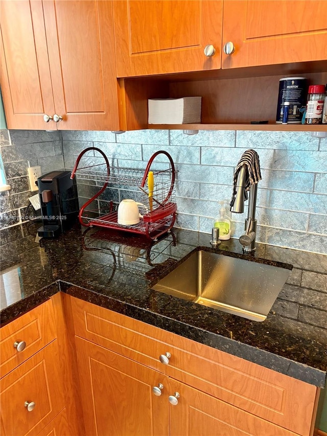 kitchen with tasteful backsplash, sink, and dark stone counters