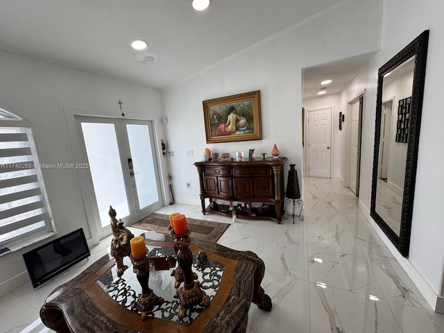 living room with french doors, a healthy amount of sunlight, and lofted ceiling