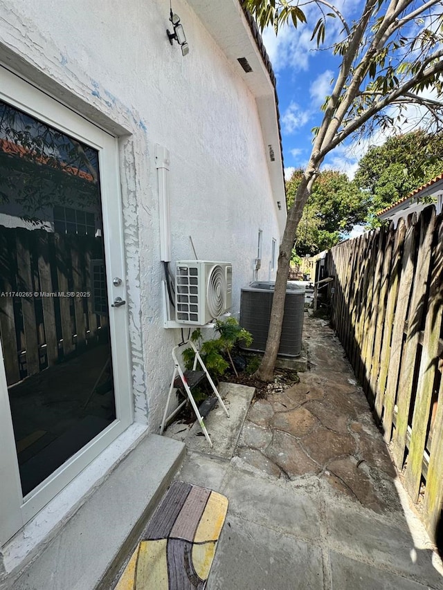 exterior space with a patio, ac unit, and central air condition unit