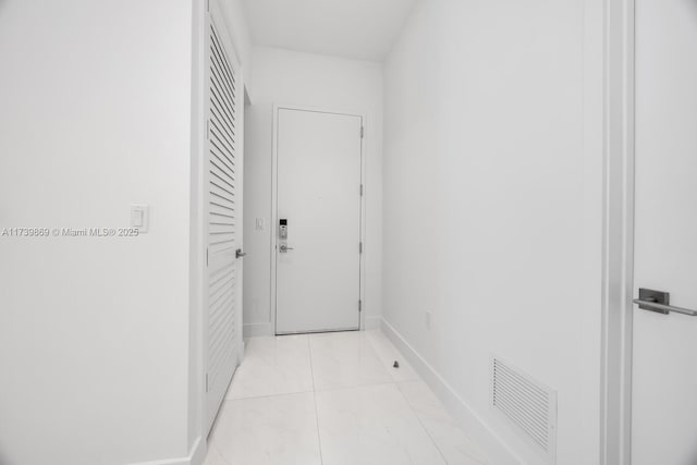 corridor featuring light tile patterned floors