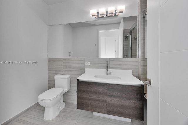 bathroom with vanity, tile walls, an enclosed shower, and toilet