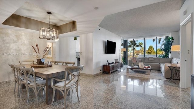 dining area featuring floor to ceiling windows, a notable chandelier, and a textured ceiling