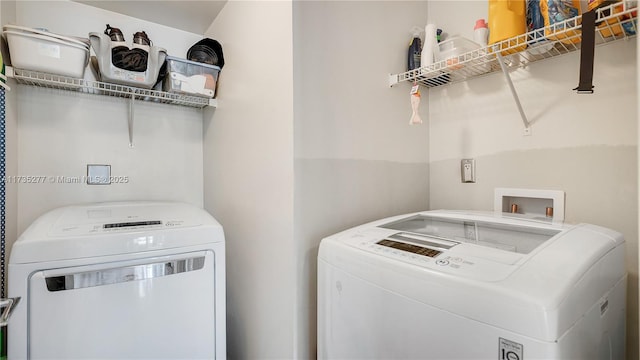 clothes washing area with independent washer and dryer