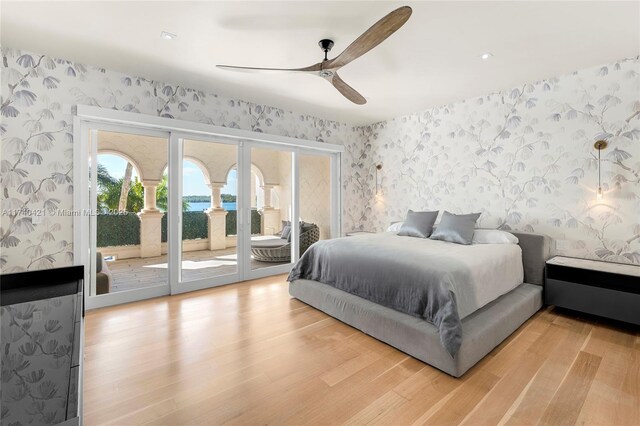 bedroom with wood-type flooring, access to outside, and ceiling fan