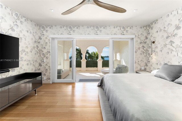 bedroom with ceiling fan, access to exterior, and light wood-type flooring