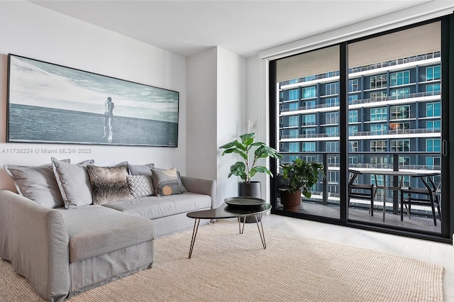 living room featuring light hardwood / wood-style flooring and a wall of windows