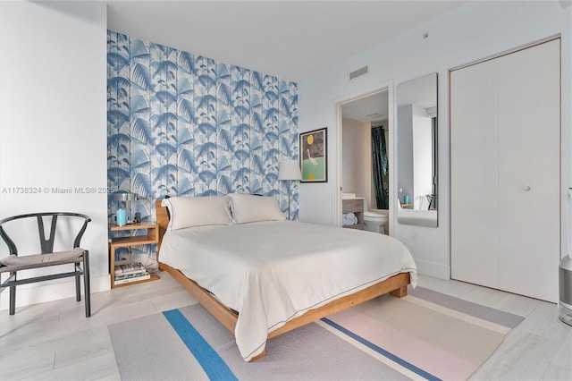 1300 S Miami Ave Unit 3408, Miami, FL 33130 - bedroom with an accent wall, wallpapered walls, and ensuite bathroom