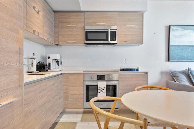 kitchen with stainless steel appliances and light brown cabinets