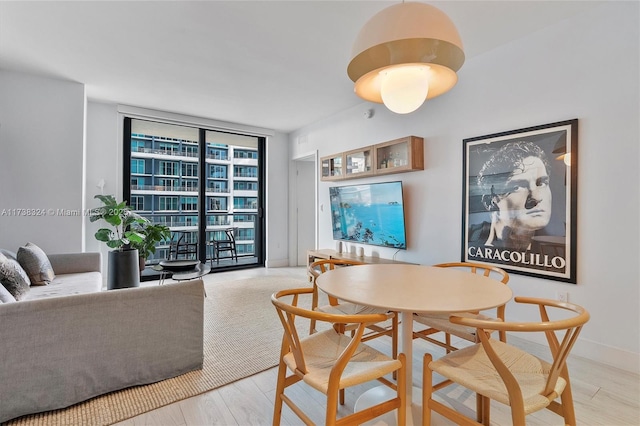 dining room featuring light hardwood / wood-style flooring and floor to ceiling windows