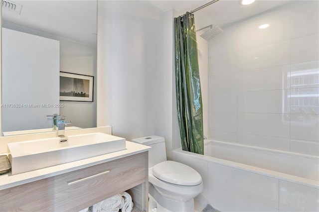 full bathroom with shower / bath combination with curtain, vanity, and toilet