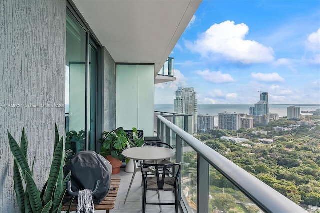 balcony featuring a water view and a grill