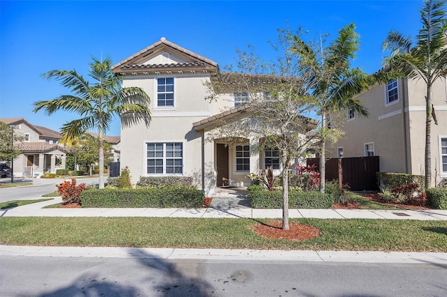 mediterranean / spanish house featuring a front lawn