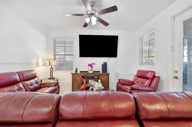 living room with a healthy amount of sunlight and ceiling fan