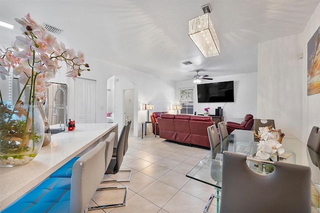 dining area featuring ceiling fan and light tile patterned floors