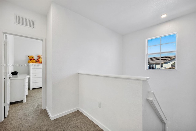 hallway with carpet flooring