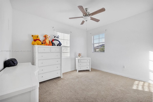 bedroom featuring ceiling fan and light carpet