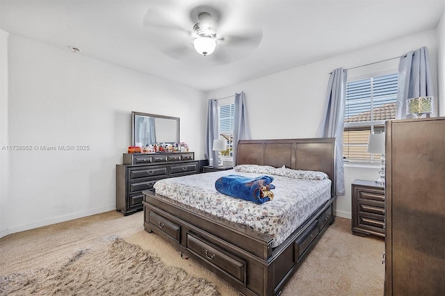 bedroom featuring light colored carpet and ceiling fan