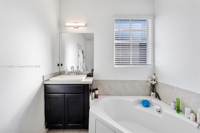 bathroom with vanity and a bath