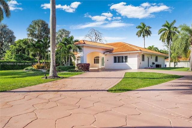 mediterranean / spanish-style home featuring a front lawn