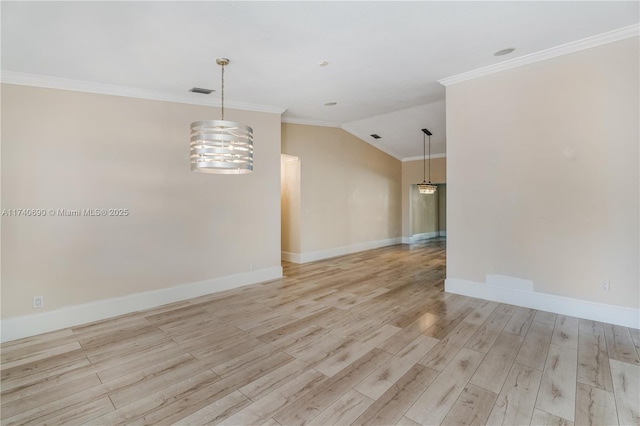 empty room with lofted ceiling, ornamental molding, and light hardwood / wood-style floors