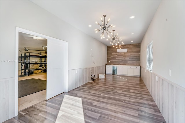 interior space with dishwashing machine, light hardwood / wood-style flooring, and a chandelier