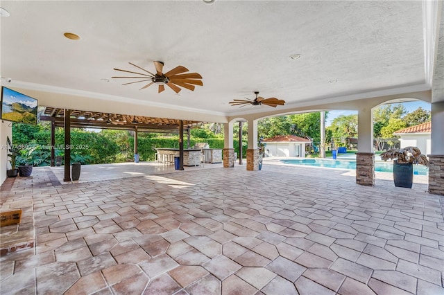 view of patio / terrace featuring a bar and ceiling fan