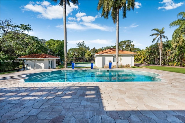 view of swimming pool with a patio and an outdoor structure