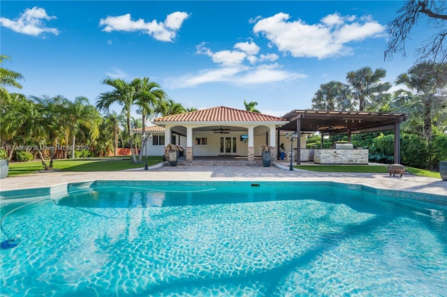 view of pool with a patio area and ceiling fan