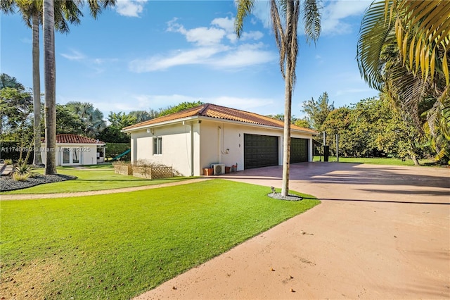 exterior space with a garage and a lawn