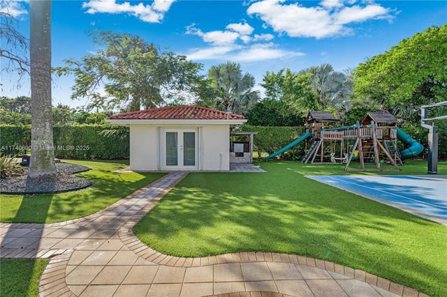 exterior space featuring an outbuilding, french doors, and a playground