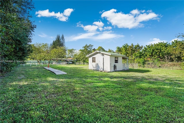 view of yard with a rural view and a storage unit