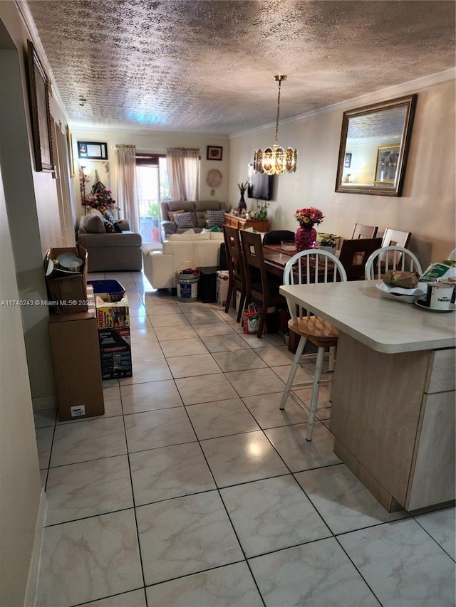 tiled dining area featuring ornamental molding and a textured ceiling