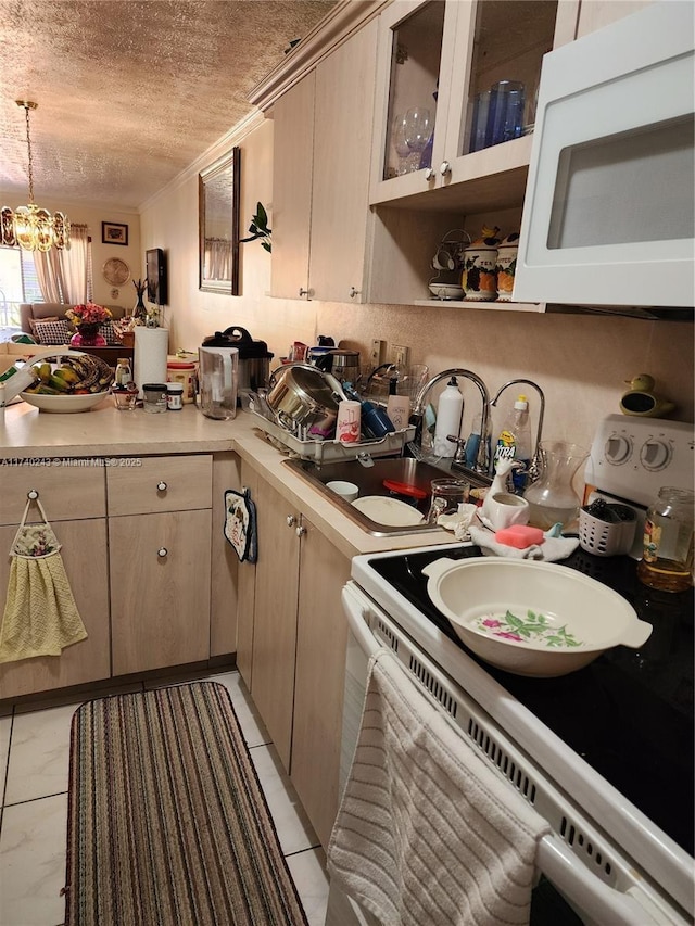 kitchen featuring pendant lighting, sink, crown molding, white appliances, and a textured ceiling