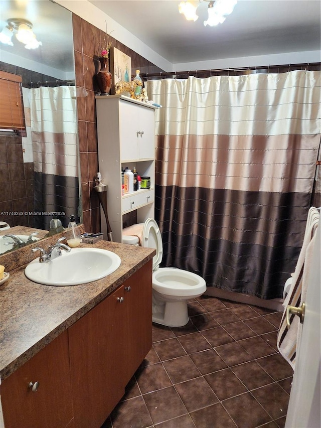 bathroom with vanity, tile patterned floors, and toilet