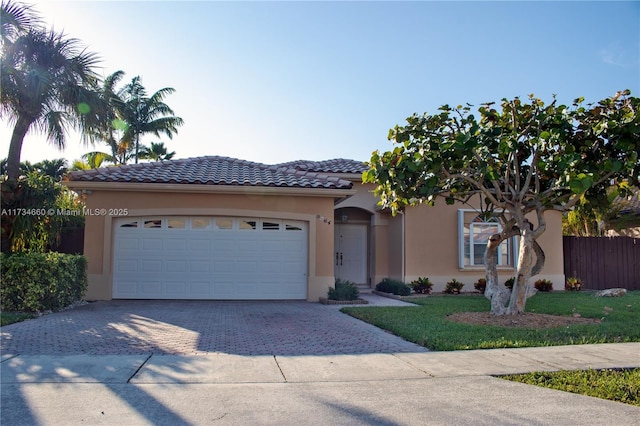 view of front facade with a garage and a front lawn