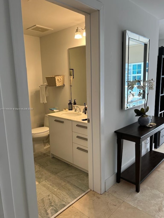 bathroom with vanity and toilet