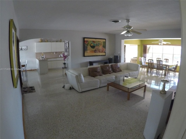 living room featuring visible vents and light speckled floor