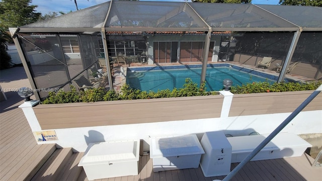 outdoor pool with a lanai and a deck