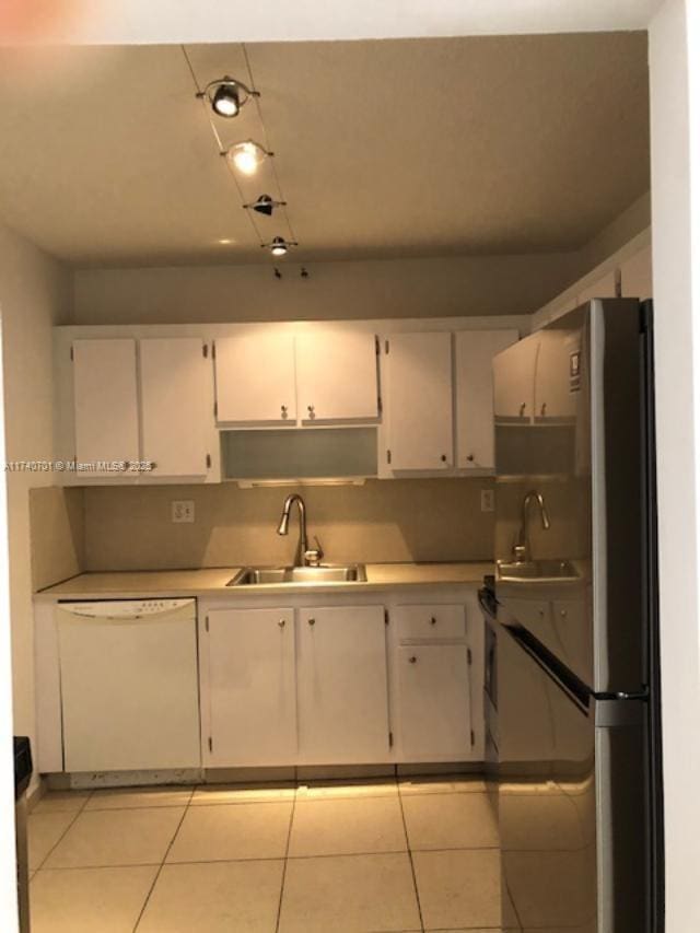 kitchen with white cabinetry, stainless steel fridge, dishwasher, and sink